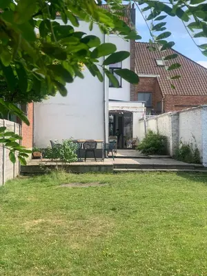 a house with a table and chairs in a yard at Heritage Mansion near Tomorrowland in Niel