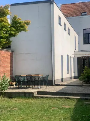a table and chairs in front of a building at Heritage Mansion near Tomorrowland in Niel