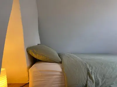 a bed with two pillows on it in a room at Charming Family Townhouse in Antwerp in Antwerp