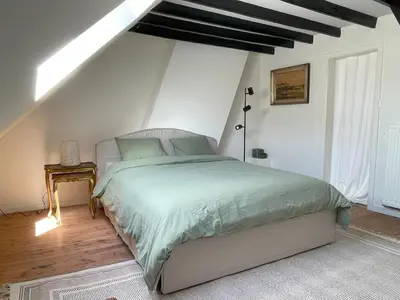 a bedroom with a large bed in a attic at Charming Family Townhouse in Antwerp in Antwerp