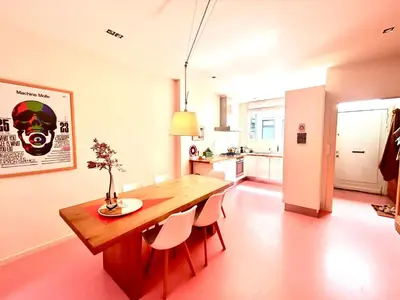 a kitchen and dining room with a wooden table and chairs at Heart of Antwerp House in Antwerp
