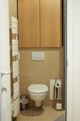 a small bathroom with a toilet and a cabinet at Elios Living Studio Mettewie in Brussels