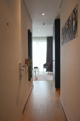 an open door to a hallway with a table at Elios Living Studio Mettewie in Brussels