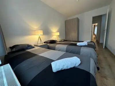 a bedroom with three beds in a room at Sleep & Explore Brussels in Brussels