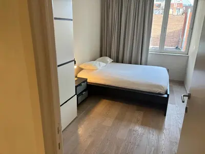 a small bedroom with a bed and a window at Sleep & Explore Brussels in Brussels