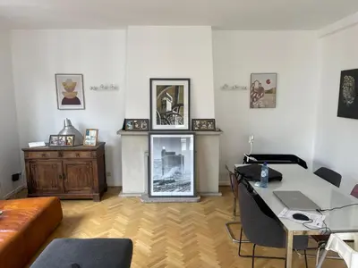 a living room with a table and a couch at Place Stéphanie - Avenue Louise - Bruxelles Centre in Brussels