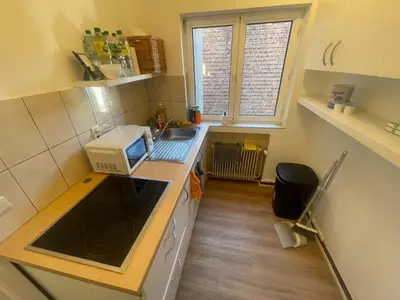 a small kitchen with a microwave and a sink at Place Stéphanie - Avenue Louise - Bruxelles Centre in Brussels