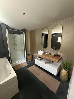 a bathroom with a sink and a tub and a mirror at Luxe Duplex te Koningshooikt in Koningshooikt