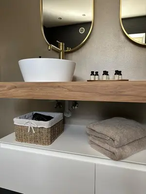 a bathroom with a sink and a mirror and towels at Luxe Duplex te Koningshooikt in Koningshooikt