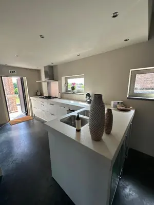 a kitchen with a sink and a counter top at Luxe Duplex te Koningshooikt in Koningshooikt