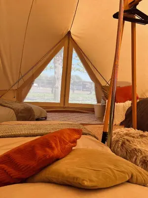a room with a tent with a large window at Glamping Josephine in Geel
