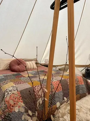 a bedroom with a bed with an umbrella at Glamping Josephine in Geel