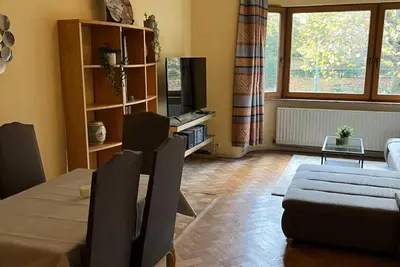 a living room with a table and a couch at Chinese Pavilion Park - Magnificent Apartment Brussels in Brussels