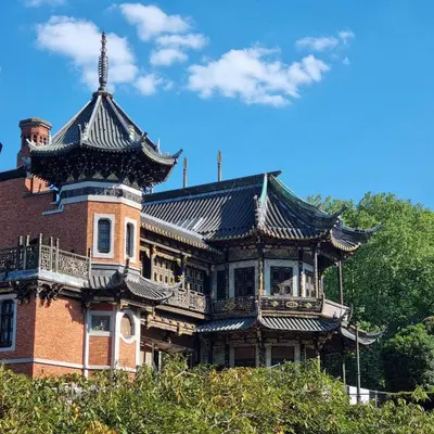 a large building with a turret on top of it at Chinese Pavilion Park - Magnificent Apartment Brussels in Brussels