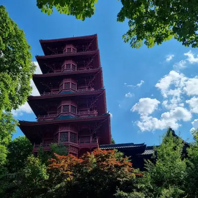 a tall building in the middle of some trees at Chinese Pavilion Park - Magnificent Apartment Brussels in Brussels
