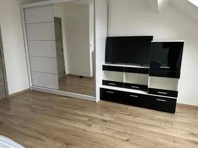 a living room with a television and a mirror at Duplex Apartment in Brussels