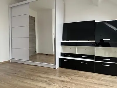 a living room with a television and a mirror at Duplex Apartment in Brussels
