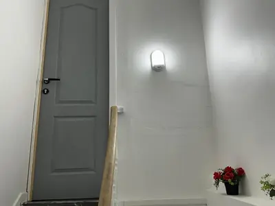 a white door with a light on the wall at Duplex Apartment in Brussels