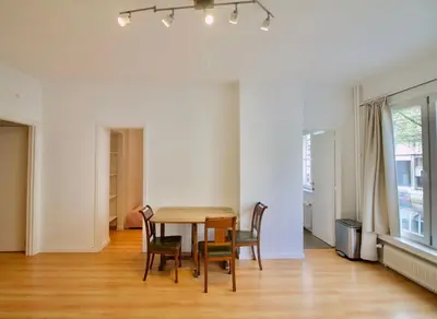 a dining room with a table and chairs at Very nice & large studio-Plasky in Brussels