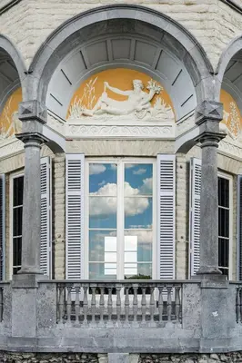 a window of a building with a reflection of the sky at Paviljoen De Notelaer in Bornem