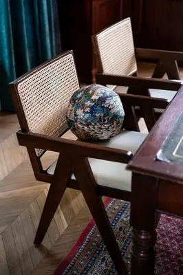 two chairs sitting next to a table in a room at Paviljoen De Notelaer in Bornem