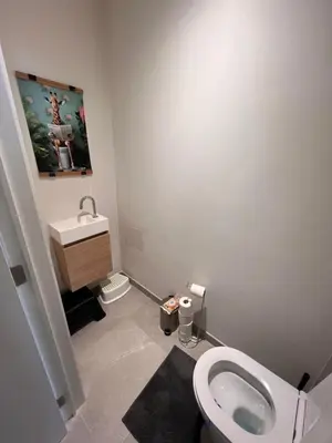 a bathroom with a white toilet and a sink at Cozy Feels, Central Vibes in Antwerp