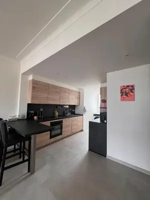 a kitchen with a black table in a room at Cozy Feels, Central Vibes in Antwerp
