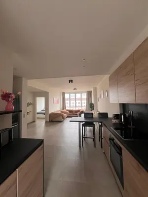 a kitchen with a table and a living room at Cozy Feels, Central Vibes in Antwerp