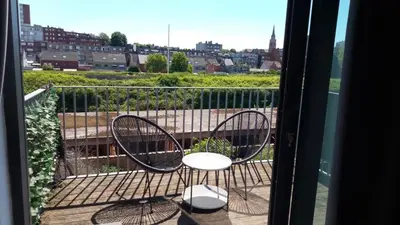 a balcony with two chairs and a view of a city at Appartement boom 2,1 km van tomorrowland in Boom