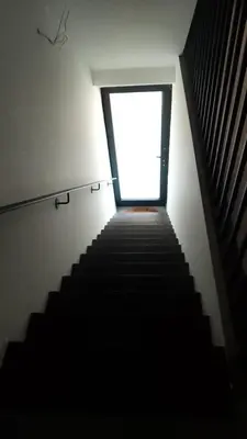 a stairway leading up to a window in a building at Appartement boom 2,1 km van tomorrowland in Boom