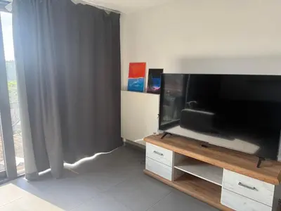 a living room with a large flat screen tv at Appartement boom 2,1 km van tomorrowland in Boom