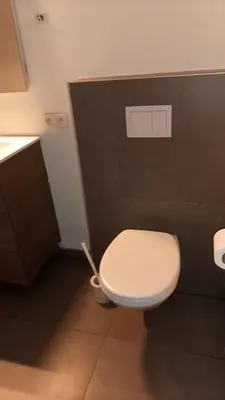 a bathroom with a white toilet and a black wall at Appartement boom 2,1 km van tomorrowland in Boom