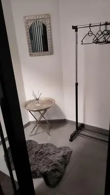 a room with a table and a mirror on the wall at Appartement boom 2,1 km van tomorrowland in Boom
