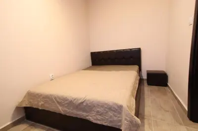 a small bedroom with a bed with a black headboard at Parkzicht Gent in Ghent