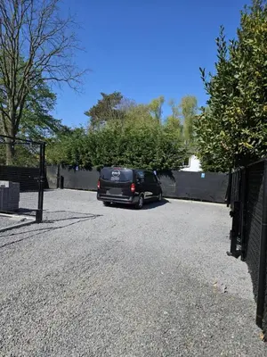 a van parked in a driveway next to a fence at Huisje in Begijnendijk