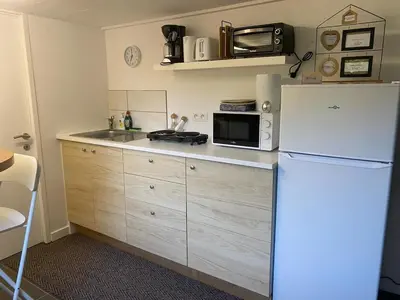 a kitchen with a white refrigerator and a microwave at Huisje in Begijnendijk