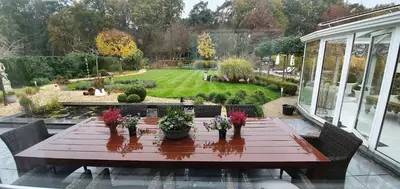 a wooden table with potted plants on a patio at thomas van der vekenlaan in Brecht