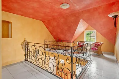 a staircase in a room with orange walls at thomas van der vekenlaan in Brecht
