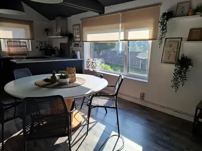 a kitchen and dining room with a table and chairs at Le Loft d'Oli in Overijse