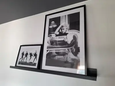 two framed pictures of a woman sitting on a chair at Le Loft d'Oli in Overijse
