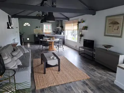 a living room with a couch and a table at Le Loft d'Oli in Overijse
