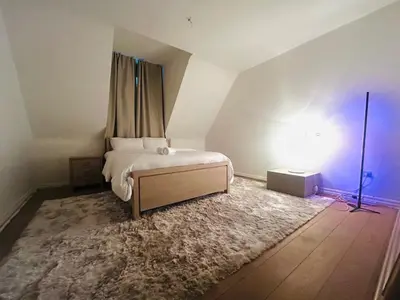 a bedroom with a bed in the corner of a room at Luxury Hotel-Villa Schaffen in Diest