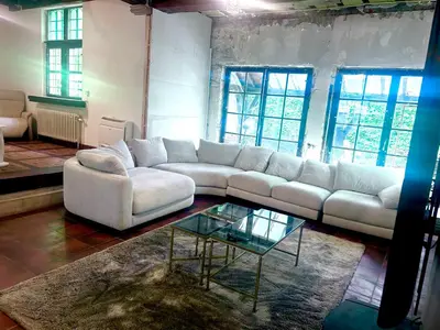 a living room with a white couch and a glass table at Luxury Hotel-Villa Schaffen in Diest