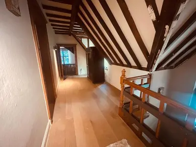 an attic hallway with a wooden ceiling and a staircase at Luxury Hotel-Villa Schaffen in Diest