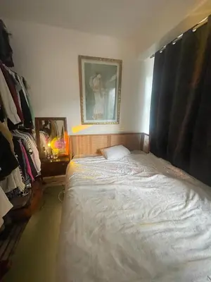 a bedroom with a bed and a picture on the wall at Petit coin de cosyness in Brussels