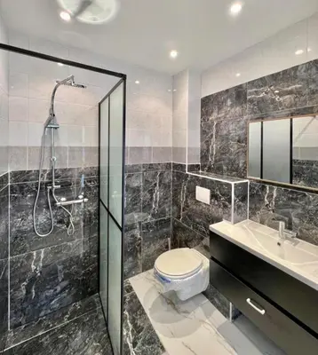 a bathroom with a shower and a toilet and a sink at Petit coin de cosyness in Brussels