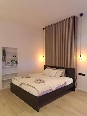 a bedroom with a large bed with a large headboard at Boomgaard de Luxe in Antwerp