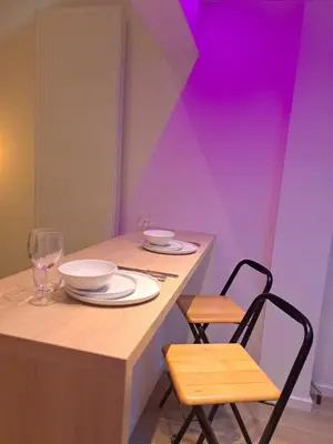a table with two chairs and a table with plates and glasses at Boomgaard de Luxe in Antwerp