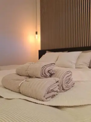 two towels are stacked on top of a bed at Boomgaard de Luxe in Antwerp