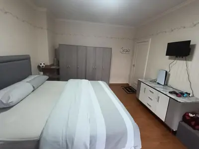 a bedroom with a large white bed and a television at Dream Home For Tomorrowland in Boom